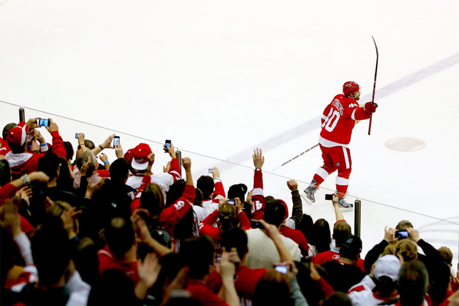 DETROIT, MI - FEBRUARY 14: Henrik Zetterberg #40 of the Detroit Red Wings salutes fans as the first star of the game after the Red Wings NHL record breaking 21st consecutive home victory defeating the Dallas Stars 3-1 at Joe Louis Arena on February 14, 2012 in Detroit, Michigan. (Photo by Gregory Shamus/Getty Images)