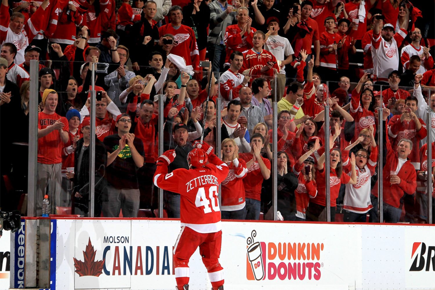 DETROIT, MI - MAY 10:  Henrik Zetterberg #40 of the Detroit Red Wings pumps his hands to the home town crowd after being named the first star of the game after Game Six of the Western Conference Quarterfinals against the Anaheim Ducks during the 2013 NHL Stanley Cup Playoffs at Joe Louis Arena on May 10, 2013 in Detroit, Michigan.  Detroit defeated Anaheim 4-3 in overtime  (Photo by Dave Reginek/NHLI via Getty Images)
